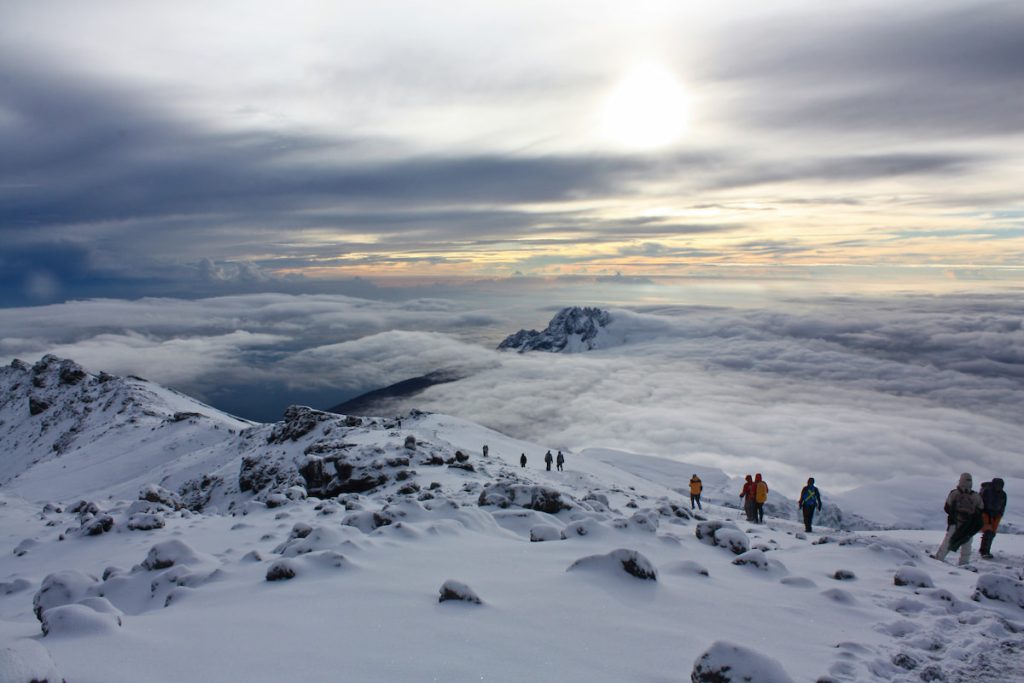 Amanecer desde la cima del Kilimanjaro con glaciares y nubes bajo los pies, Tanzania